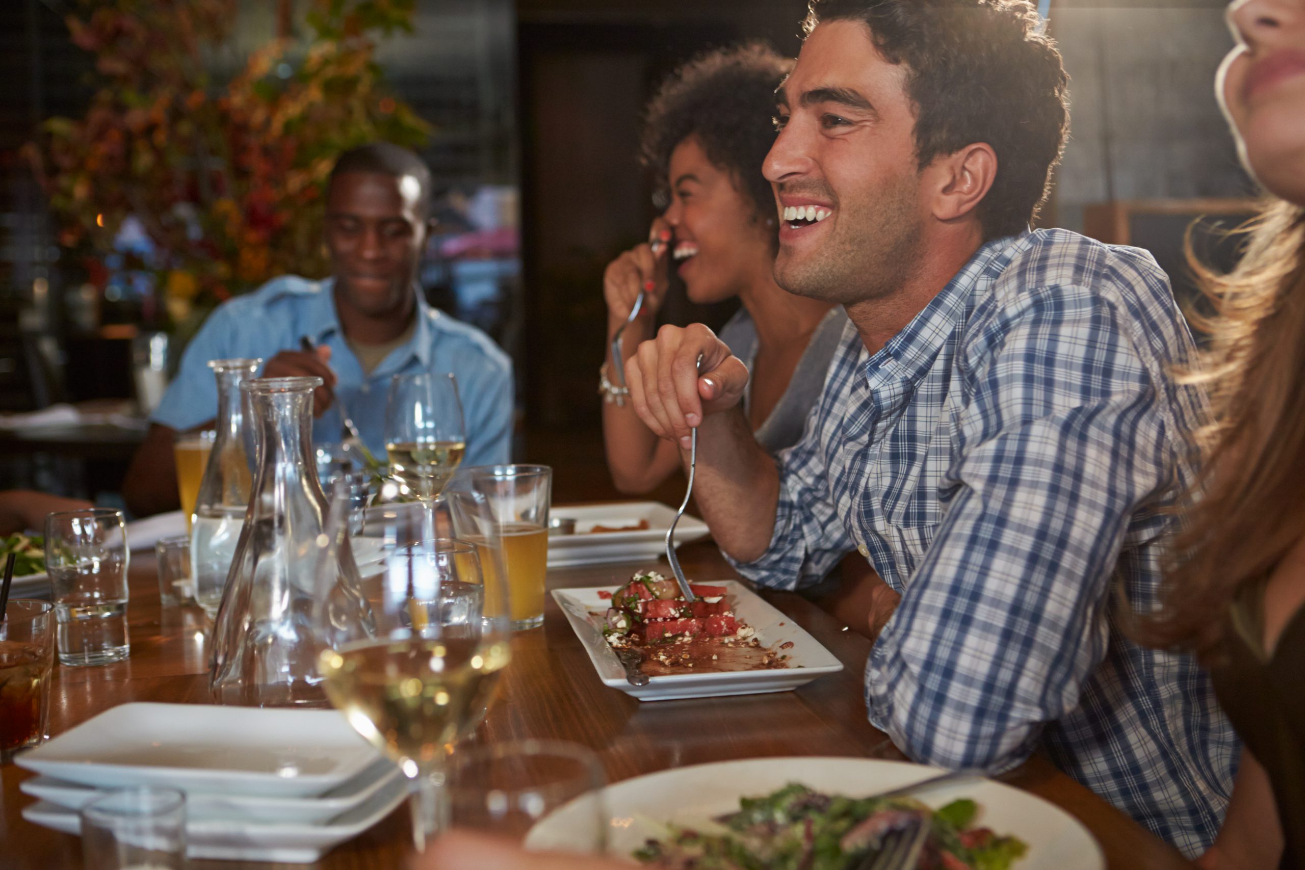 Group of friends laughing at restaurant